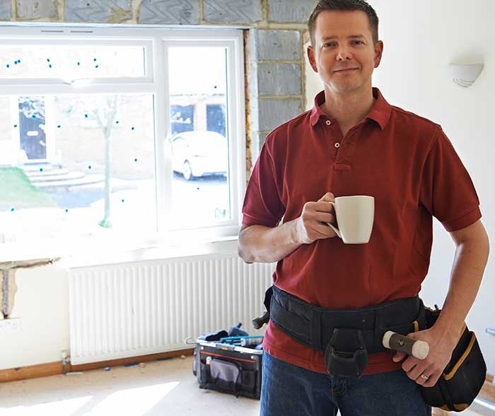 Construction worker drinking coffee during an emergency restoration